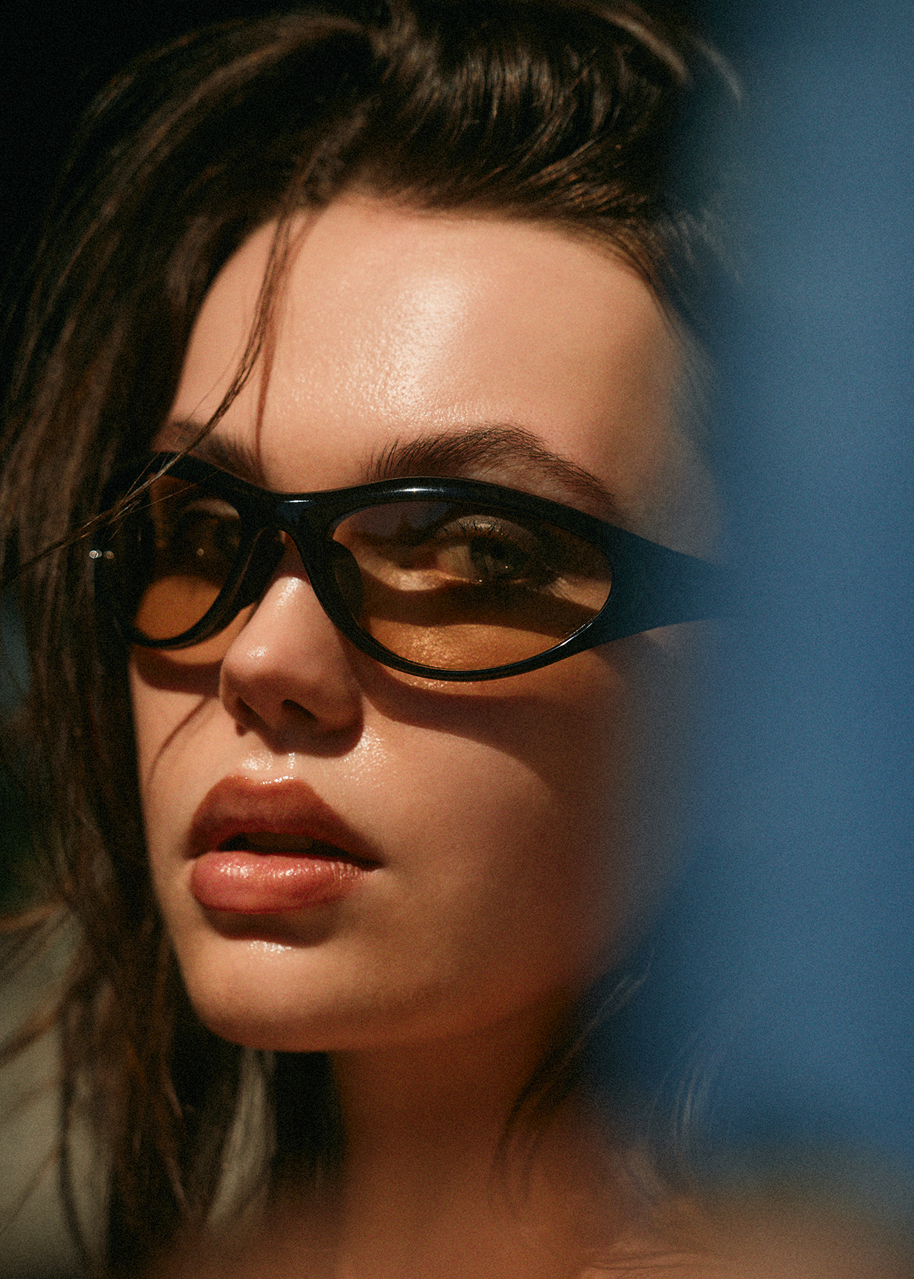Close up portrait of Caroline Cummings in sunglasses looking longingly at the camera